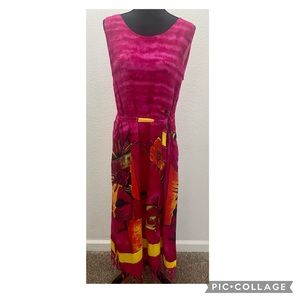 Magenta maxi dress with pockets, ties and has tassels at the bottom of dress